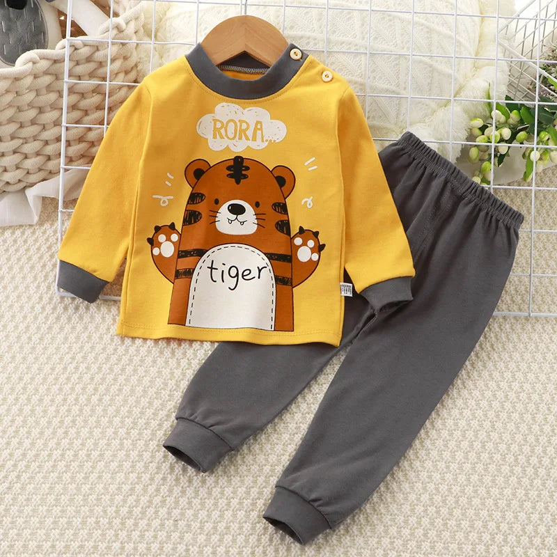 A baby girl's outfit set with long sleeves, featuring Minnie Mouse character designs, hanging on a wooden hanger.
