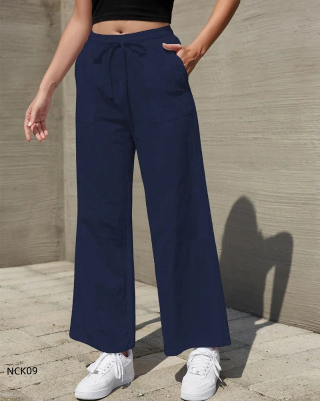 Person wearing navy wide-leg pants with a neutral background