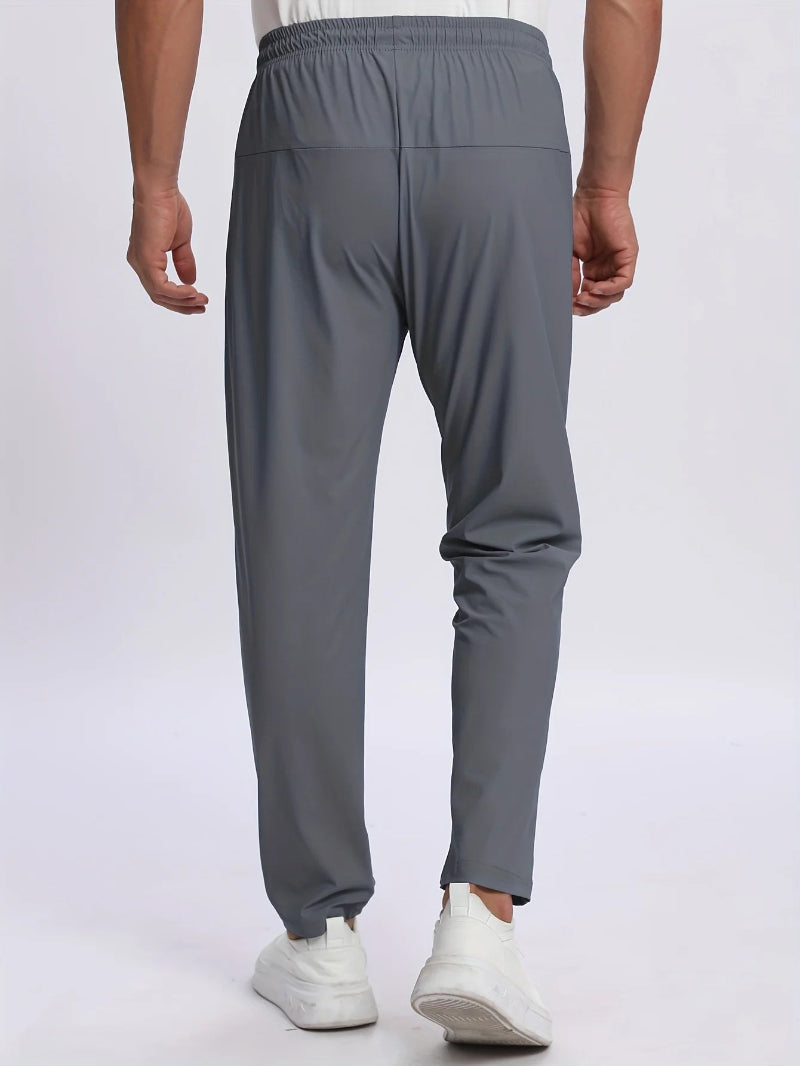 Person wearing gray pants on a white background