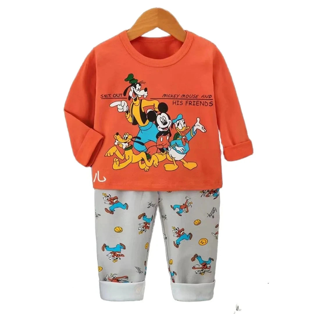 Children's outfit with orange top and gray pants featuring cartoon characters on a white background.