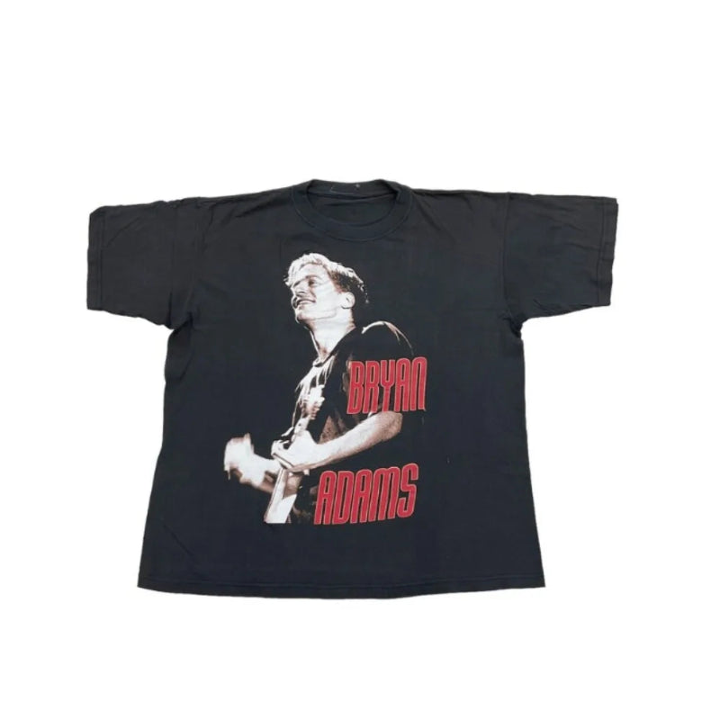 Black t-shirt with a graphic of a person playing guitar and 'Bryan Adams' text on a white background