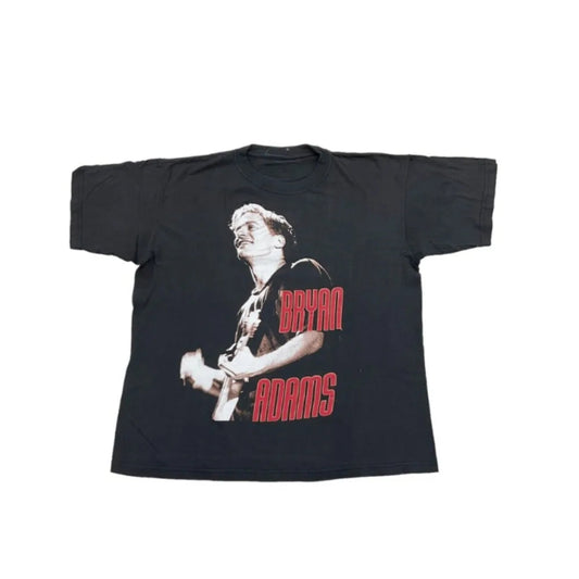 Black t-shirt with a graphic of a person playing guitar and 'Bryan Adams' text on a white background