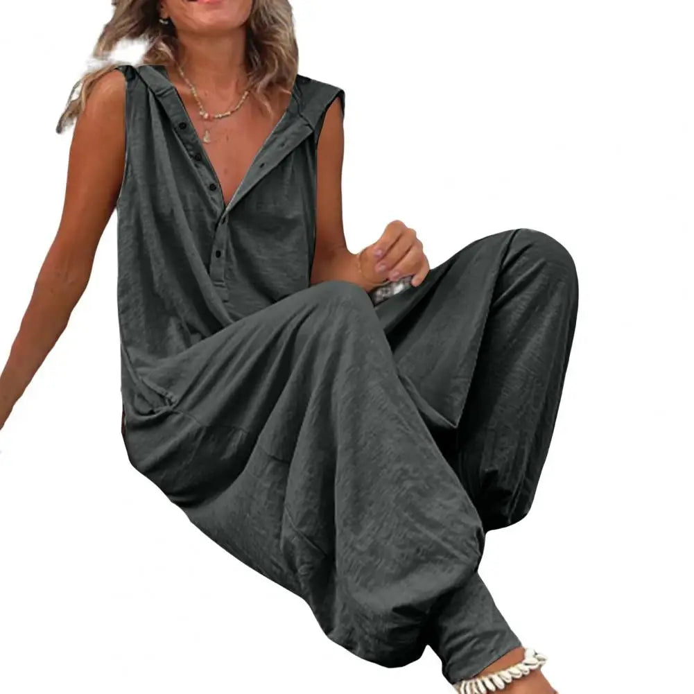 Woman wearing a gray sleeveless jumpsuit on a white background