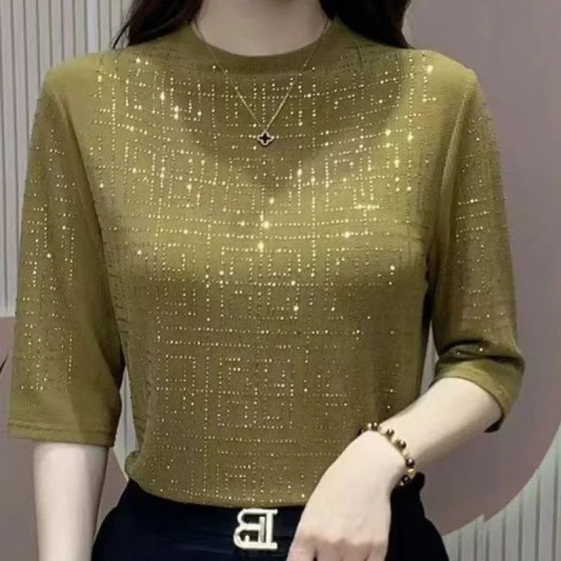 Green glittery top worn by a mannequin against a neutral background