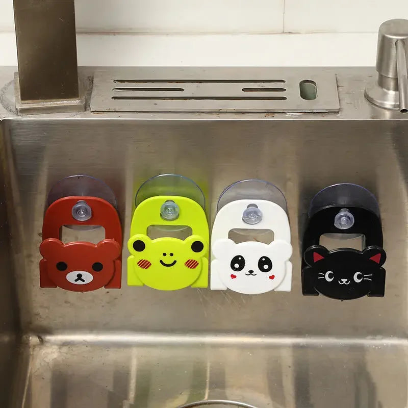 Five colorful bottle openers with animal designs attached to a kitchen sink.