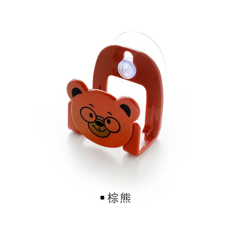 Red bear-shaped phone holder with a light on a white background