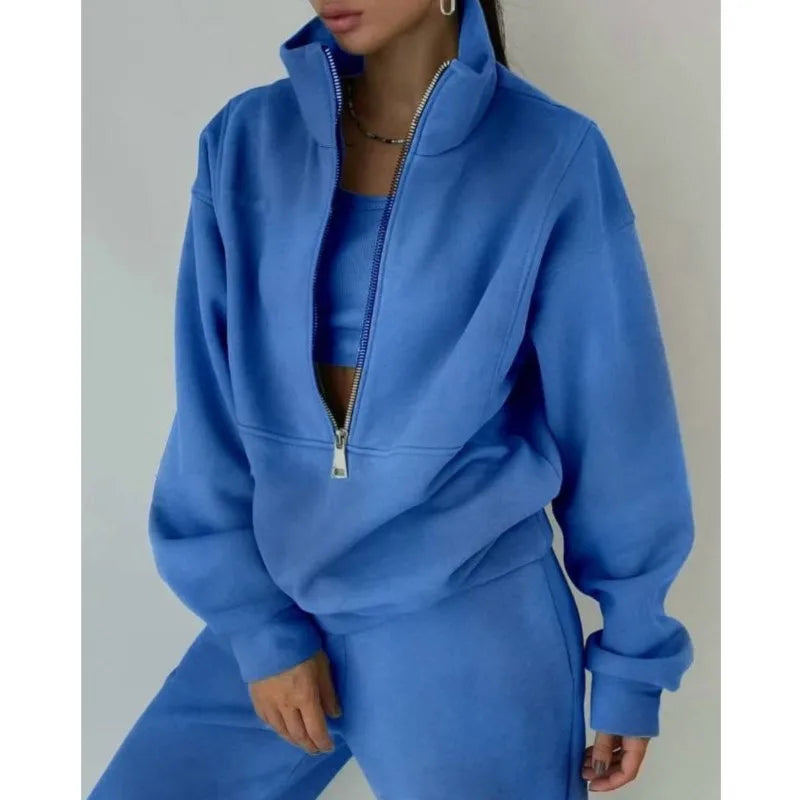 Person wearing a blue tracksuit against a plain background