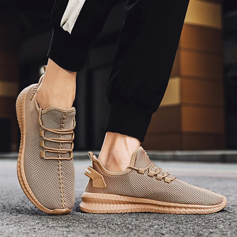 Beige sneakers worn with black pants on a blurred background