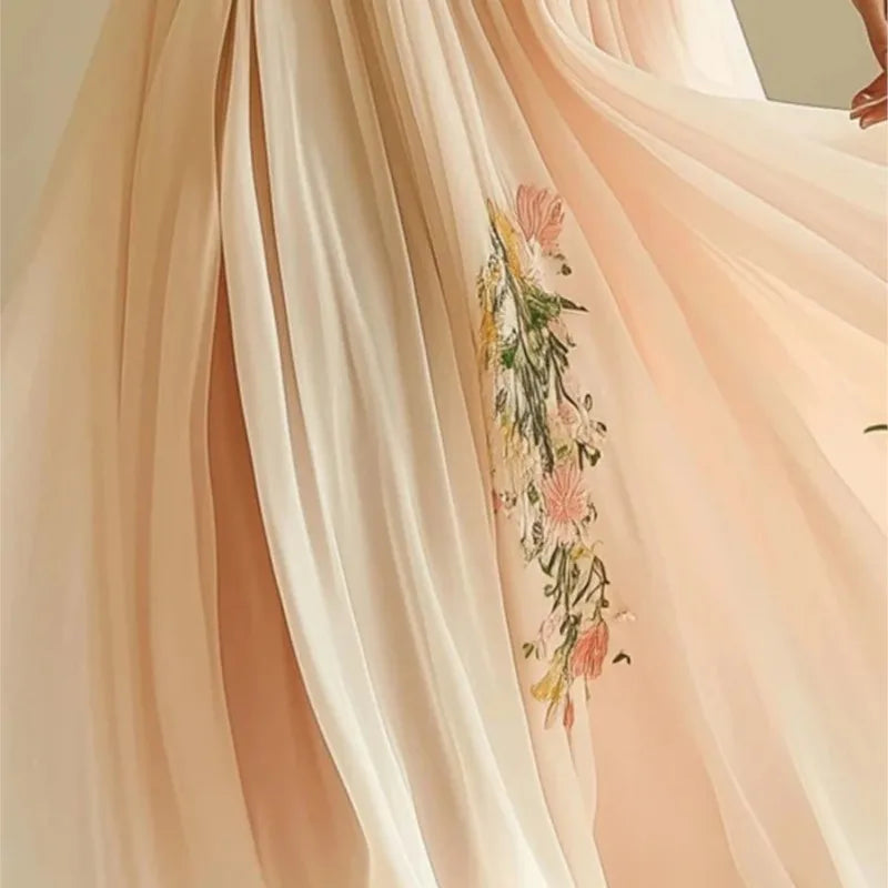 Delicate peach-colored fabric with floral embroidery
