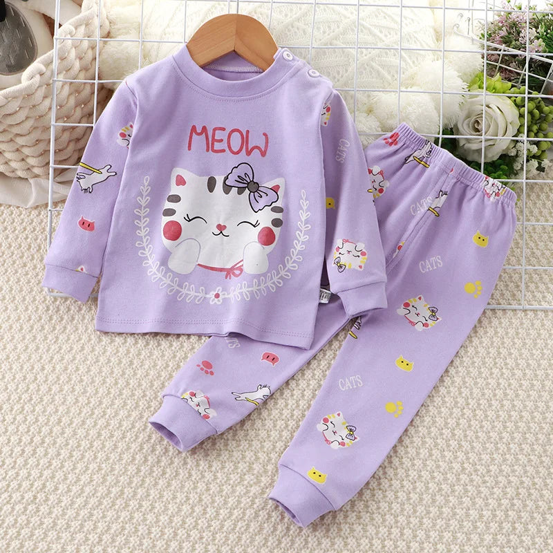 A baby girl's outfit set with long sleeves, featuring Minnie Mouse character designs, hanging on a wooden hanger.