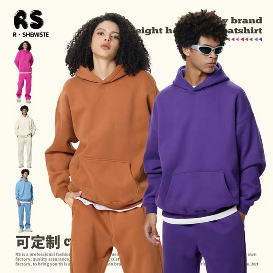 Two people wearing brown and purple hoodies with matching pants, with RS Shemistee branding.