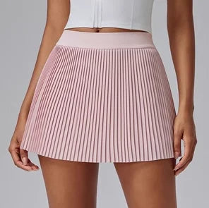 Pink pleated skirt worn by a person on a plain background