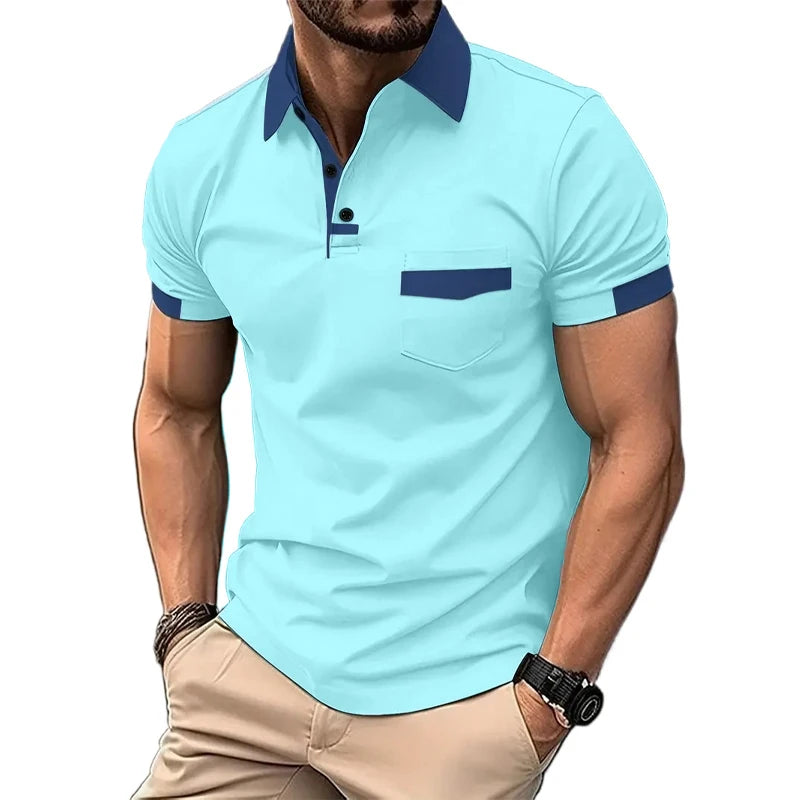A man wearing a short-sleeved beige polo shirt with blue collar and pocket trim, and light beige shorts.