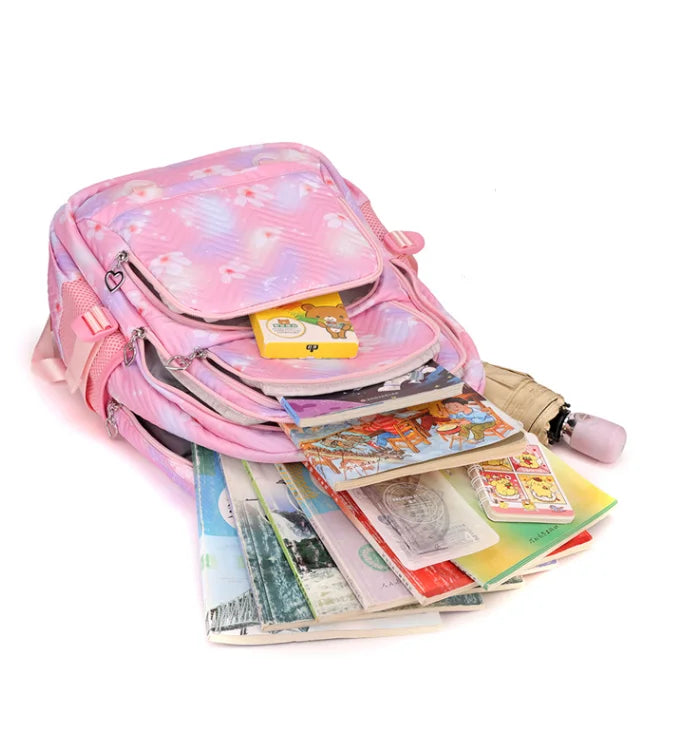 Pink backpack with books and a toy on a white background