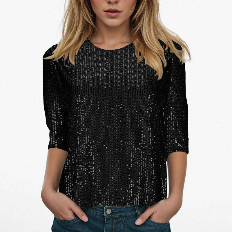 Black sequin top worn by a person on a white background