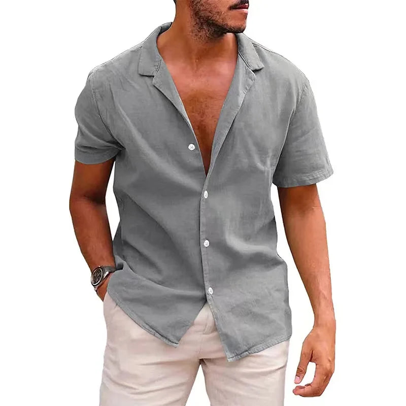 Man wearing a gray short-sleeve button-up shirt on a white background