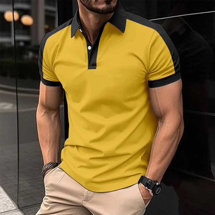 A man wearing a red and black patchwork polo shirt with short sleeves and a collar.