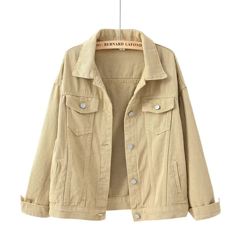 Beige denim jacket on a hanger with a white background