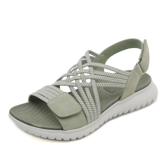 Green sandal with braided straps on a white background
