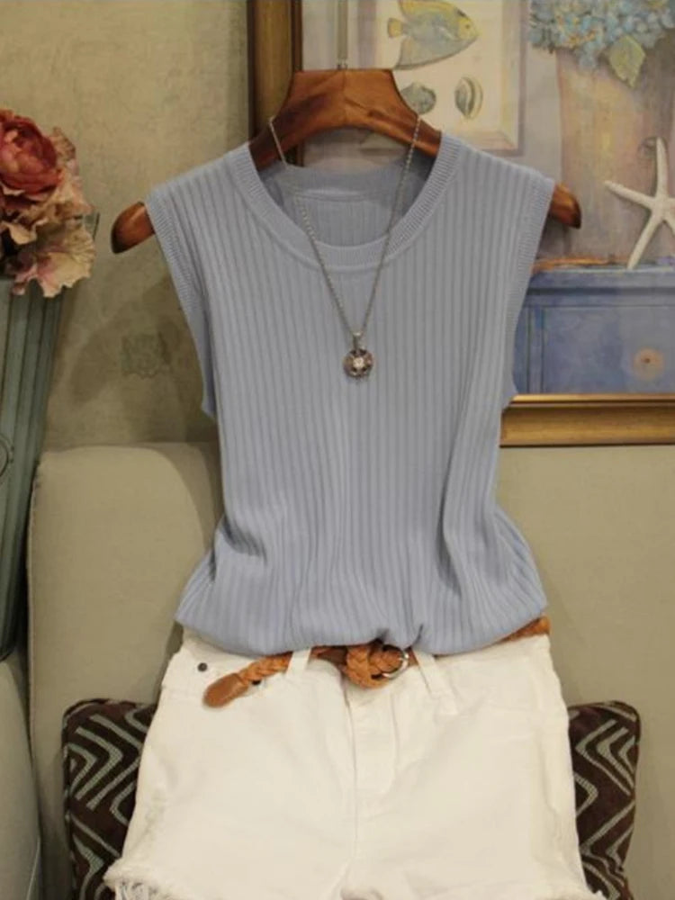 Light blue sleeveless top on a hanger with a neutral background