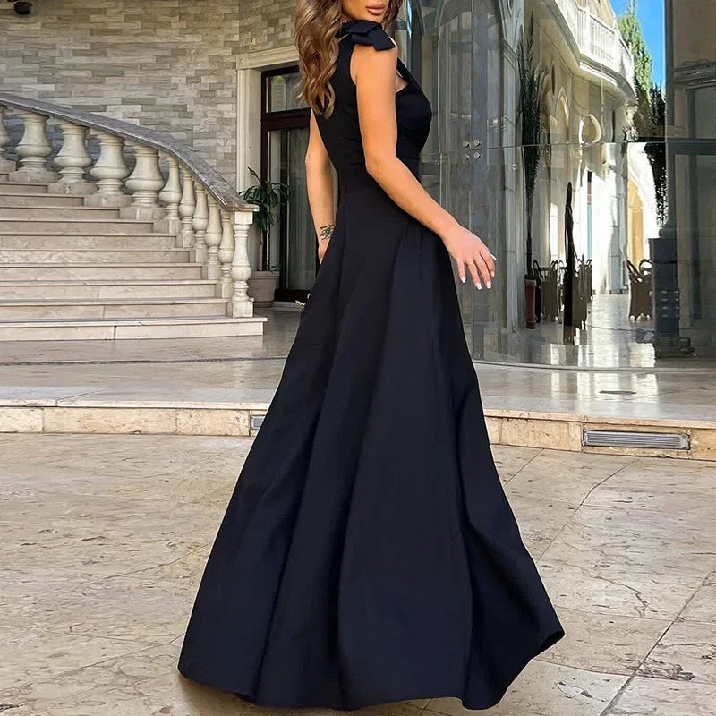 Woman wearing a black evening gown in an elegant outdoor setting