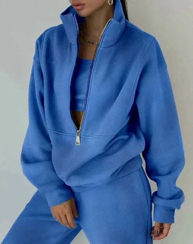 Person wearing a blue tracksuit against a plain background