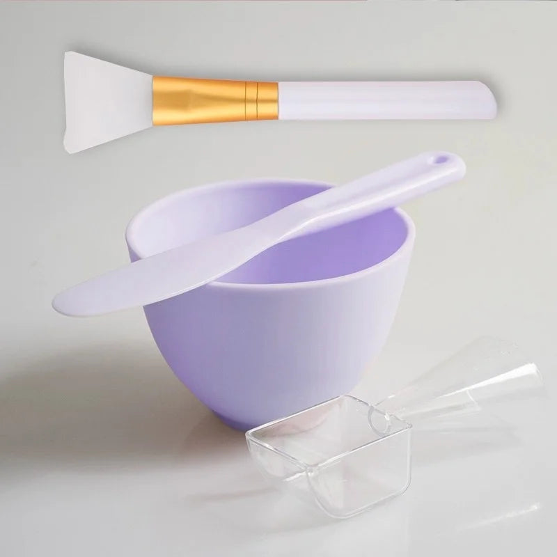 Purple mixing bowl with a spatula and a small container on a light gray background