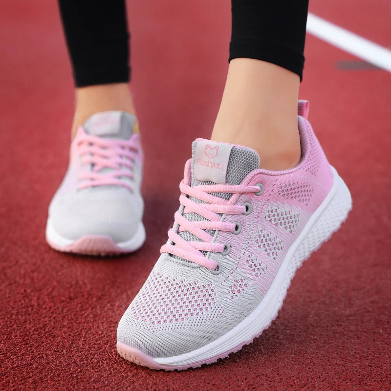 Pink and gray sneakers on a red surface