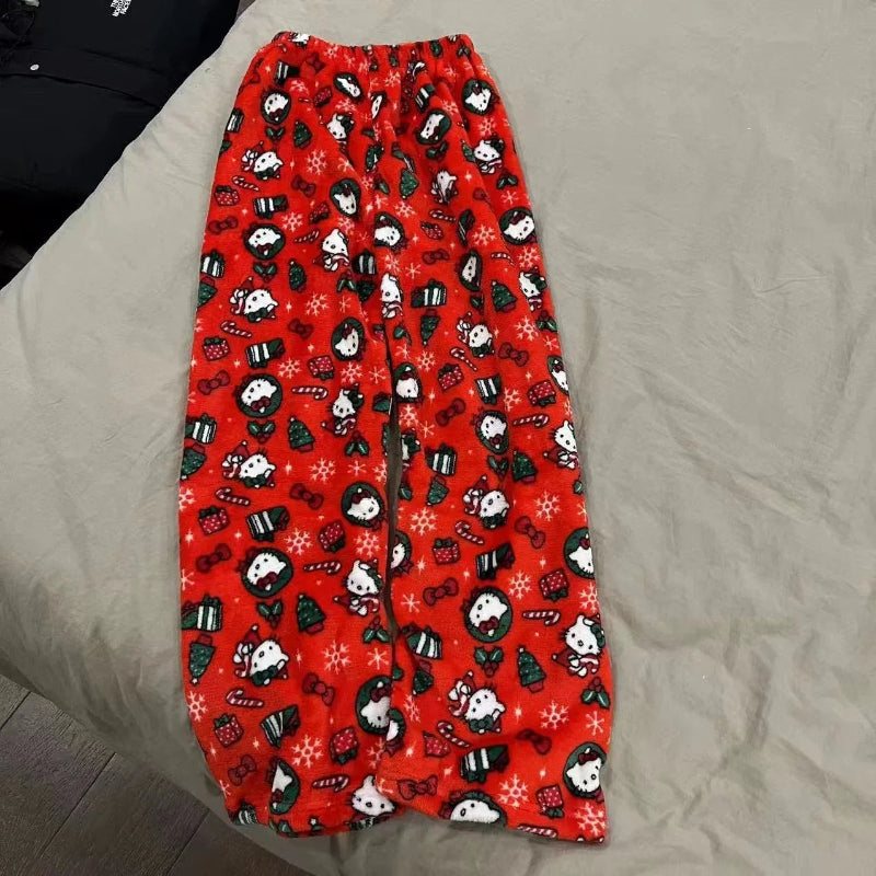 Red pajama pants with black and white character pattern on a beige surface