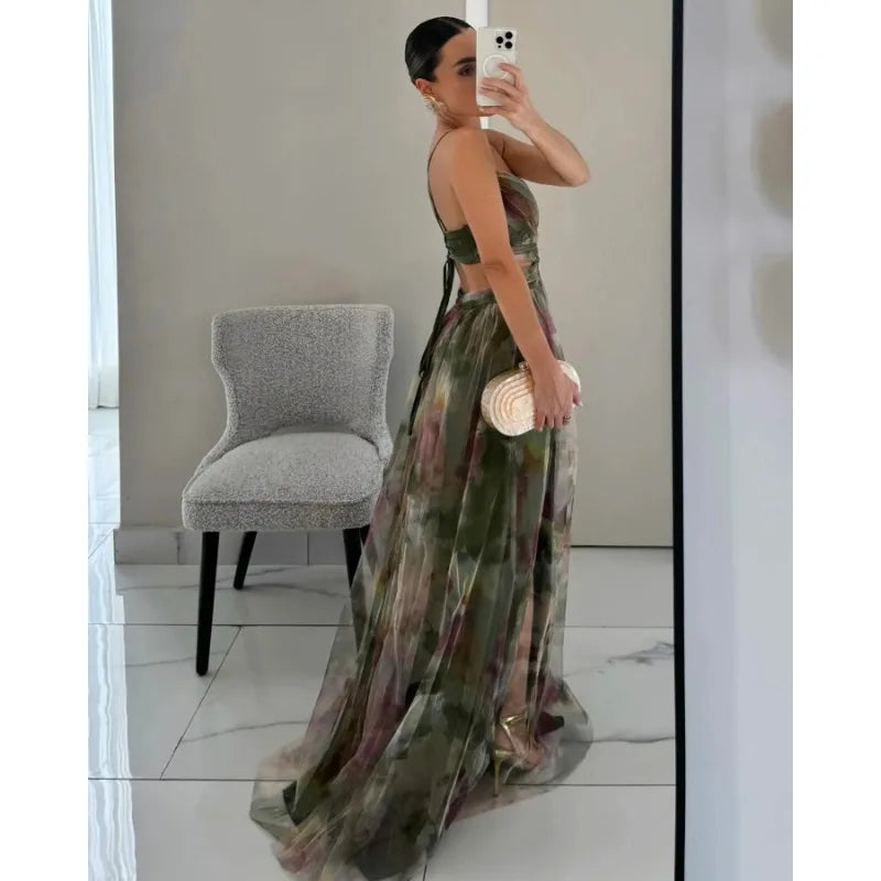 Woman taking a mirror selfie wearing a floral dress in a room with a chair.