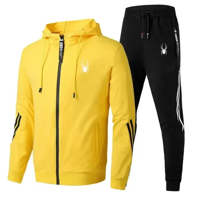 Yellow hoodie and black pants with a spider logo on a white background
