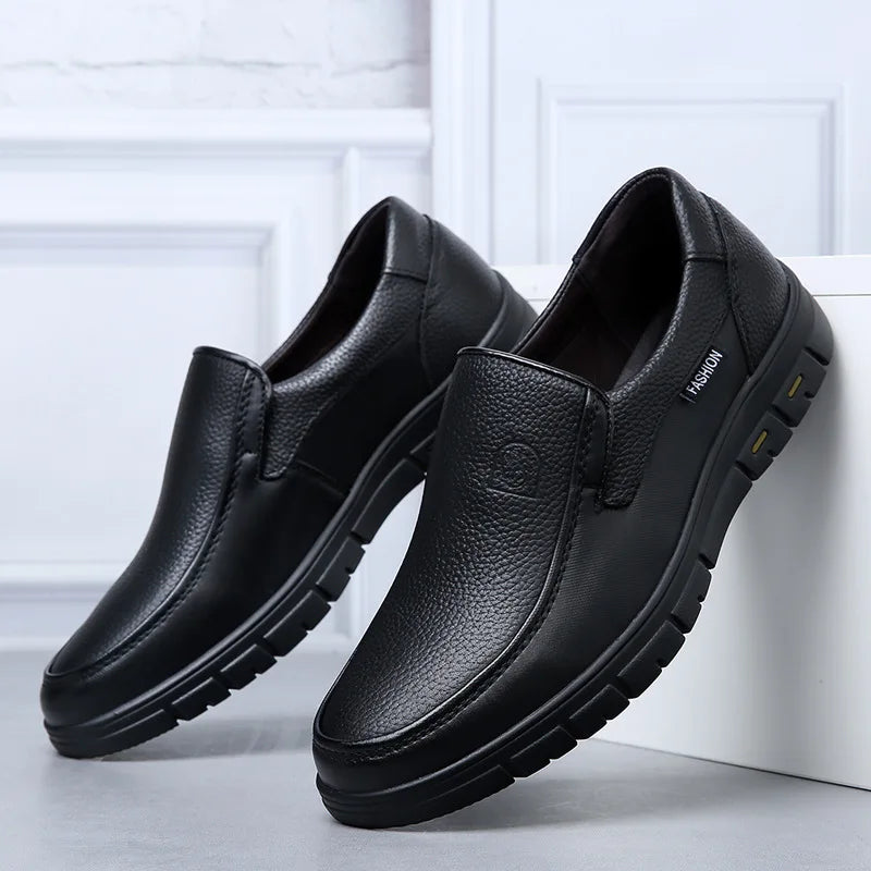 Pair of black leather shoes on a light gray background