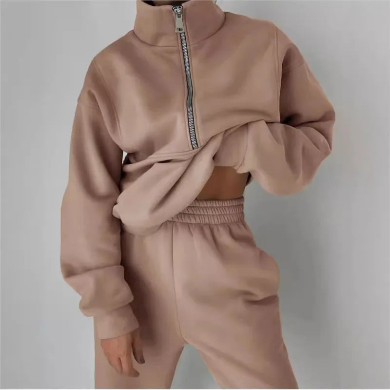 Beige tracksuit with a half-zip design on a plain background