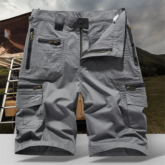 Gray cargo shorts with multiple pockets and zippers on a neutral background