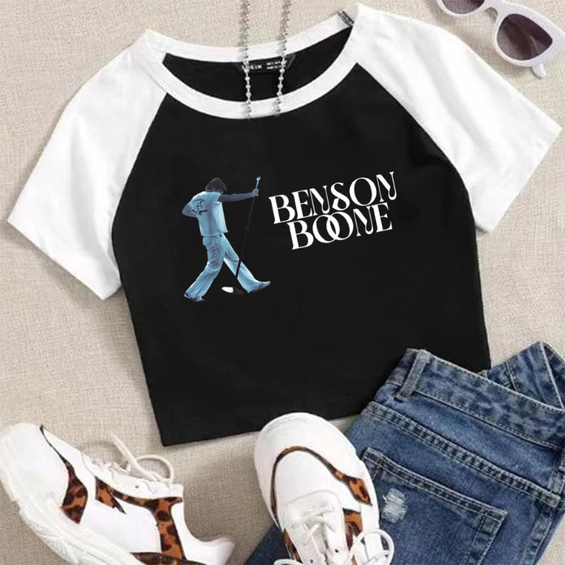 Black and white baseball shirt with 'Benson Boone' design, paired with jeans and sneakers on a neutral background.