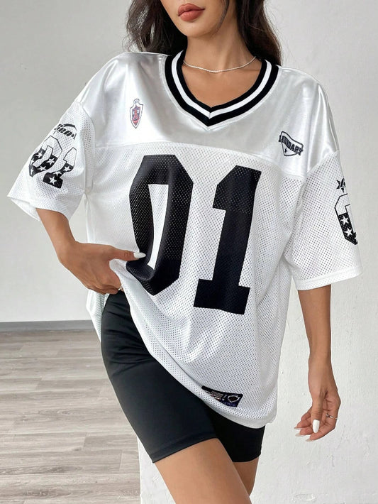A woman wearing a black V-neck sports jersey with the number '01' on it. The jersey has white text and trim, and it appears to be made of polyester fabric.
