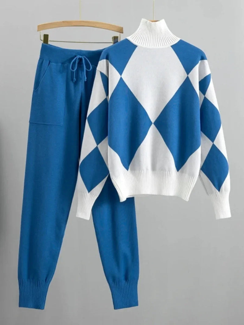 Blue and white argyle sweater with matching pants on a hanger against a gray background
