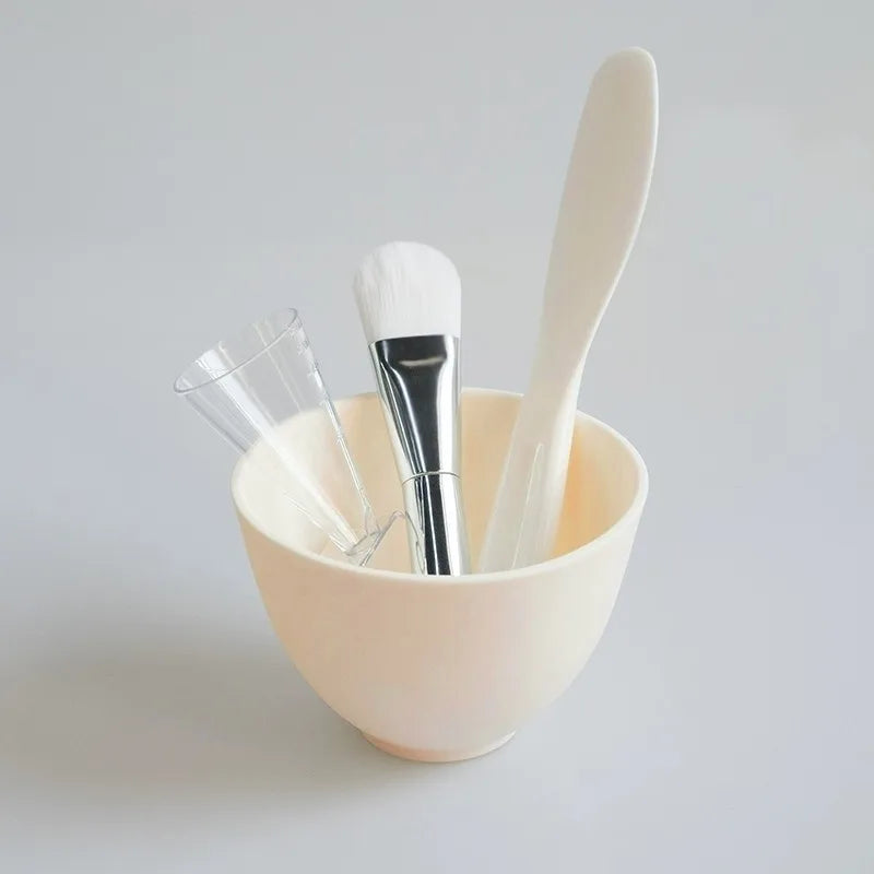 Set of makeup brushes in a beige bowl on a light gray background