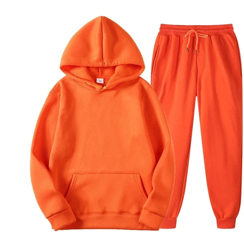 Orange hoodie and pants set on a white background