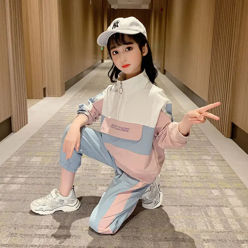 Child wearing a colorful outfit with a white cap in an indoor setting
