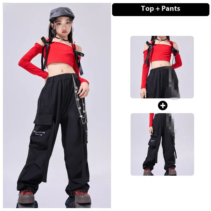 Person wearing a red top and black pants with suspenders on a gray background