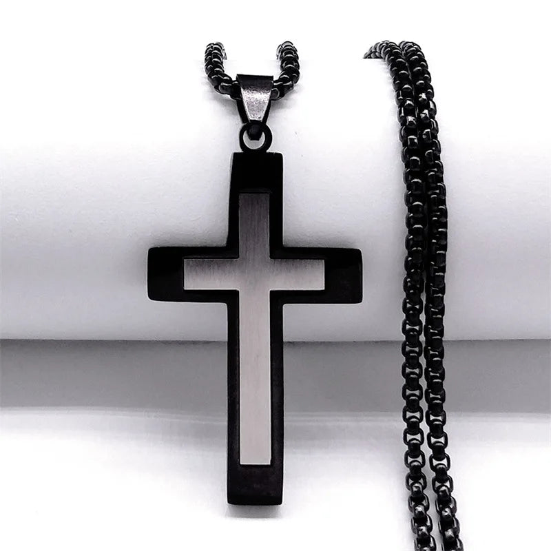 Black cross pendant necklace on a white background
