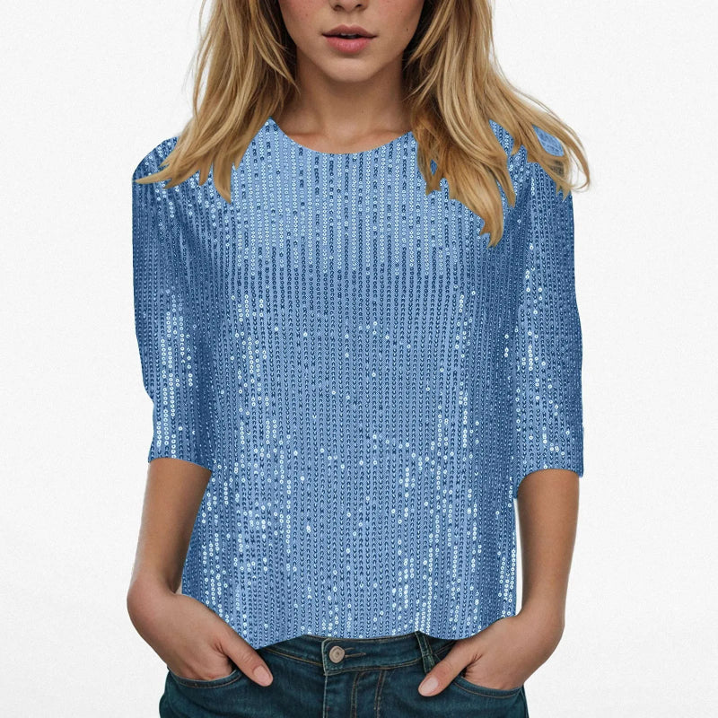 Woman wearing a blue sequin top on a white background