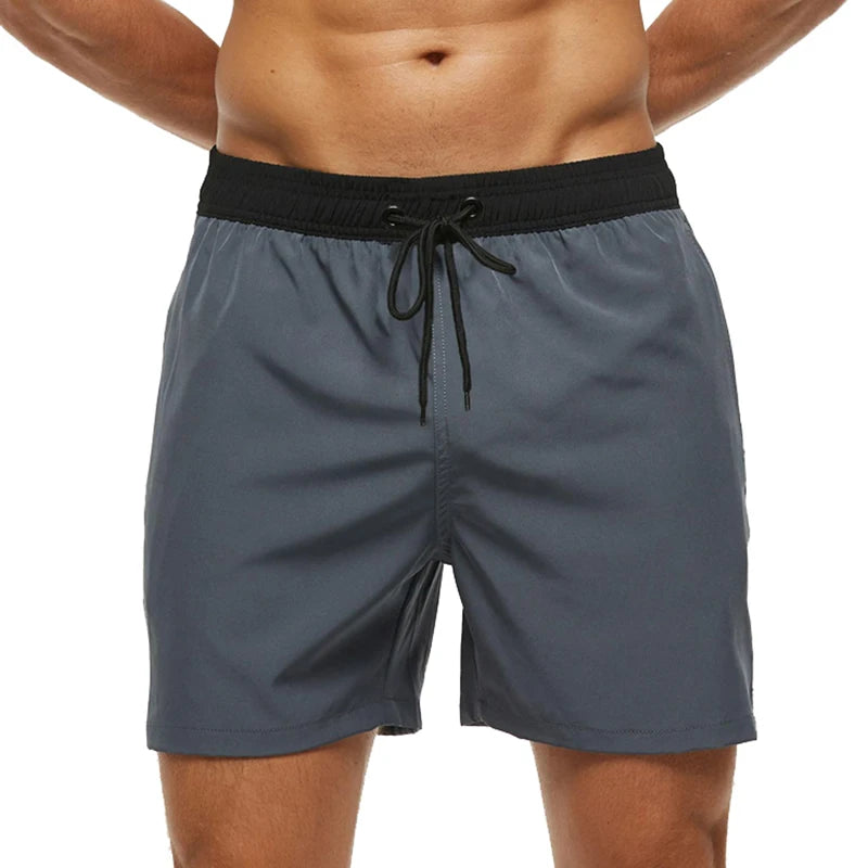 Gray shorts with a black drawstring on a white background