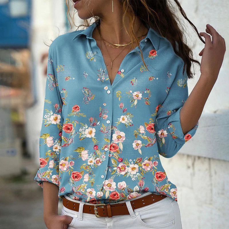 Woman wearing a blue floral shirt with a blurred background