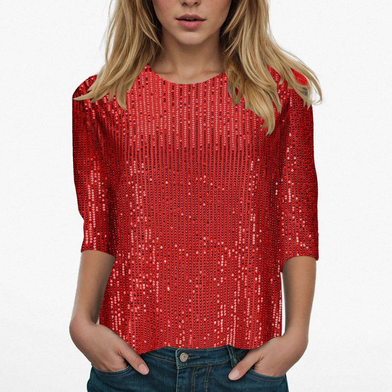 Person wearing a red sequin top on a white background