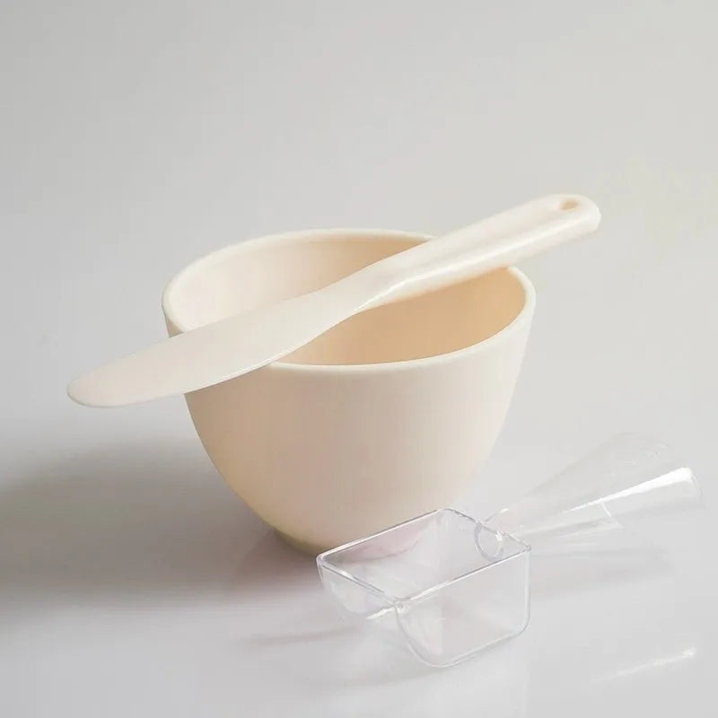 White ceramic bowl with a matching spoon on a light gray background