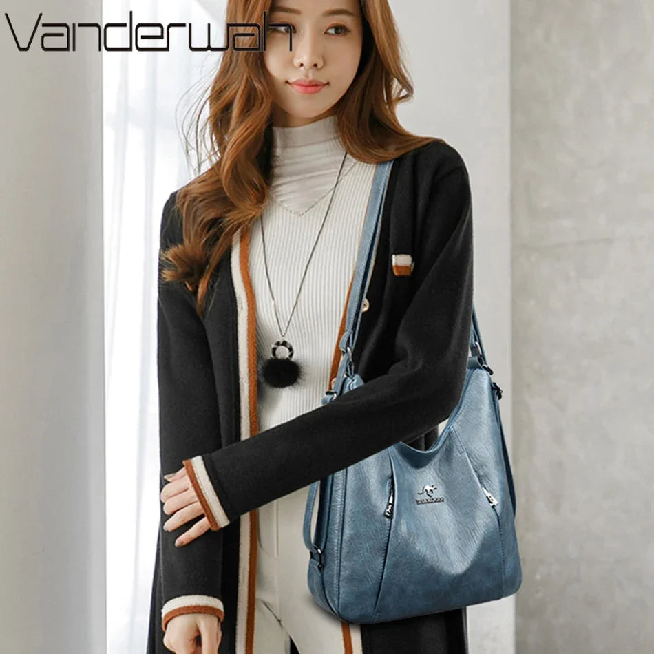 Woman holding a blue handbag with a neutral background