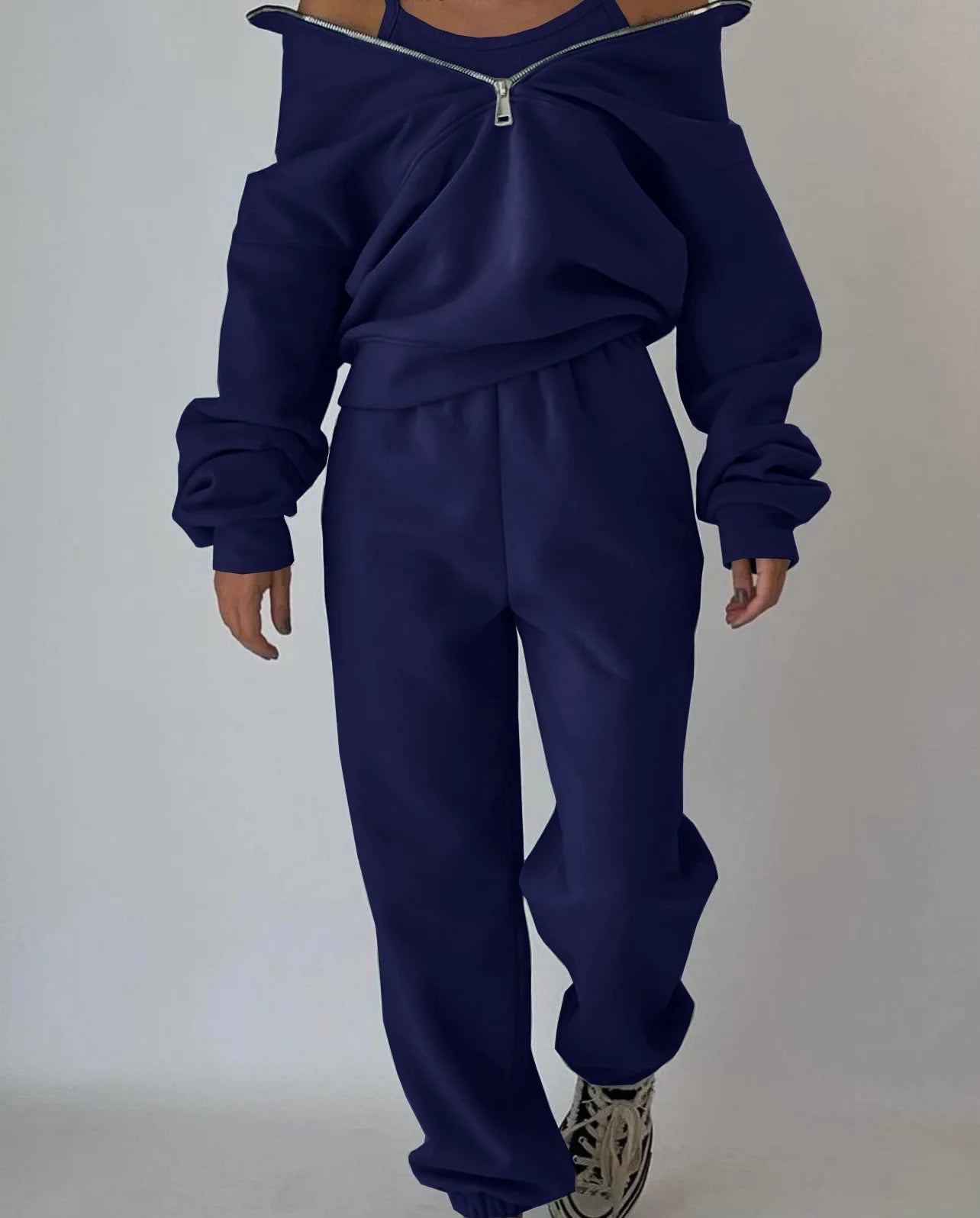 Navy blue tracksuit worn by a person on a plain background