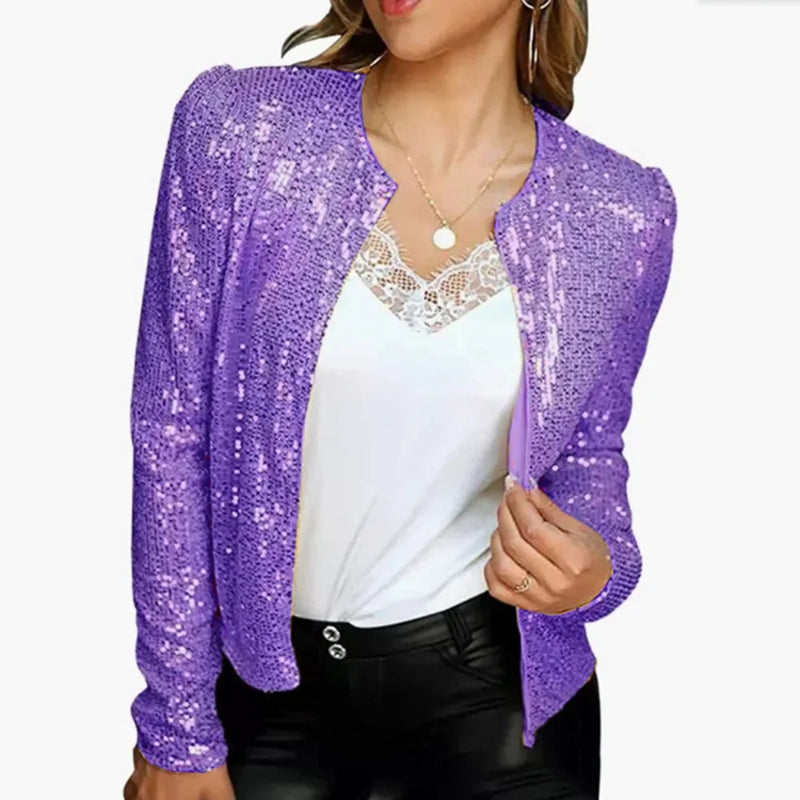 Purple sequin cardigan over a white top and black pants on a white background